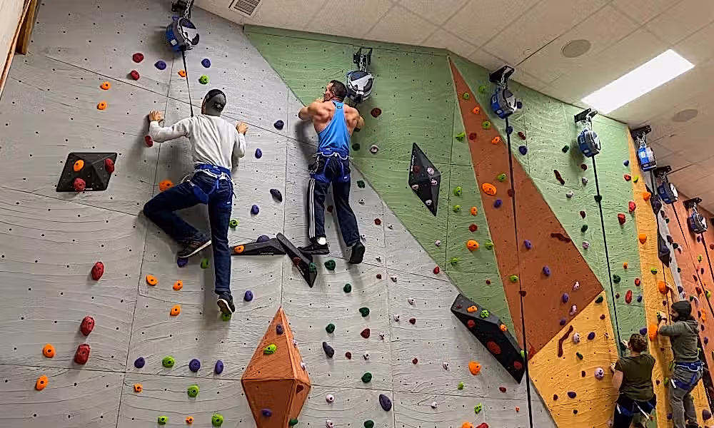 Two men rock climbing.