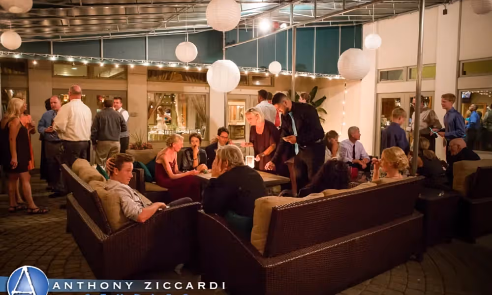 Wedding guests around fire pit at Black Bear outdoor seating area