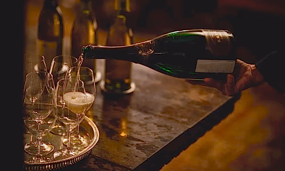 White wine being poured into glasses.
