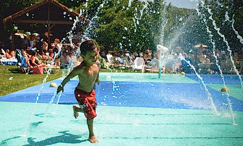 Child running through spray ground at Minerals Hotel