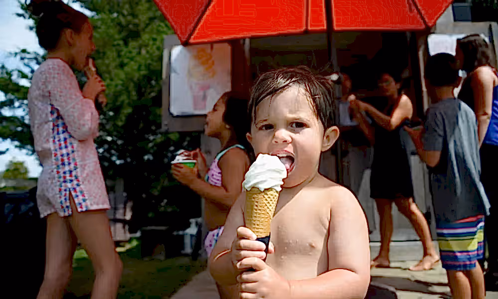 Young boy eating vanilla ice cream cone by the pool at Minerals Hotel in NJ