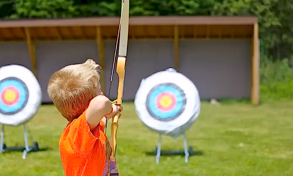 Boy doing archery target practice 