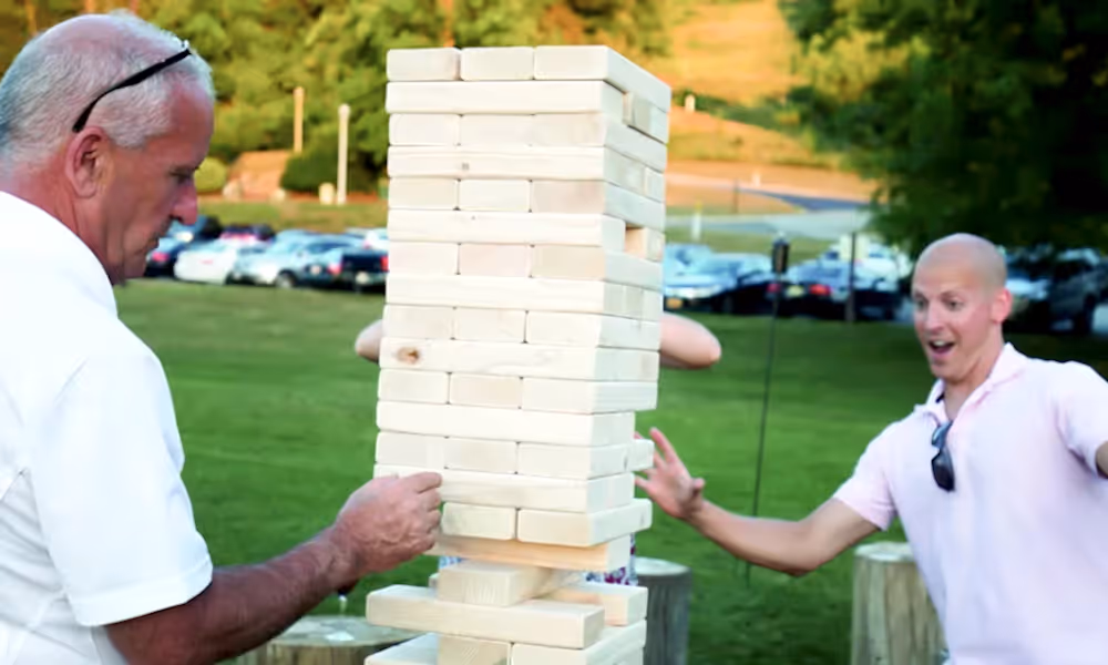 Guys participating in Giant Jenga a teambuilding activity at Crystal Springs Resort