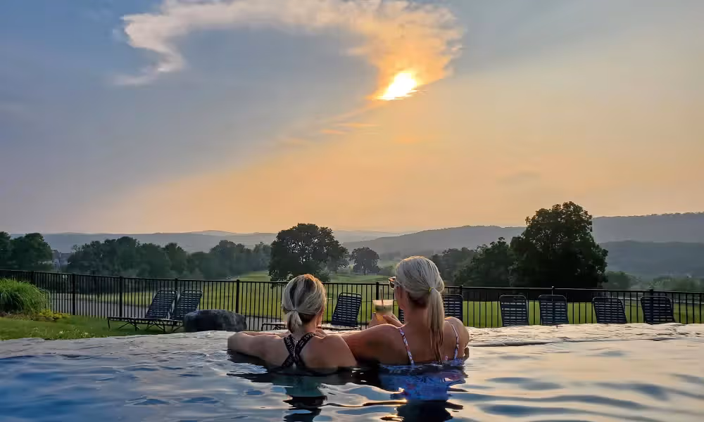 Two women at the Vista 180 overlooking the beautiful view of the mountains