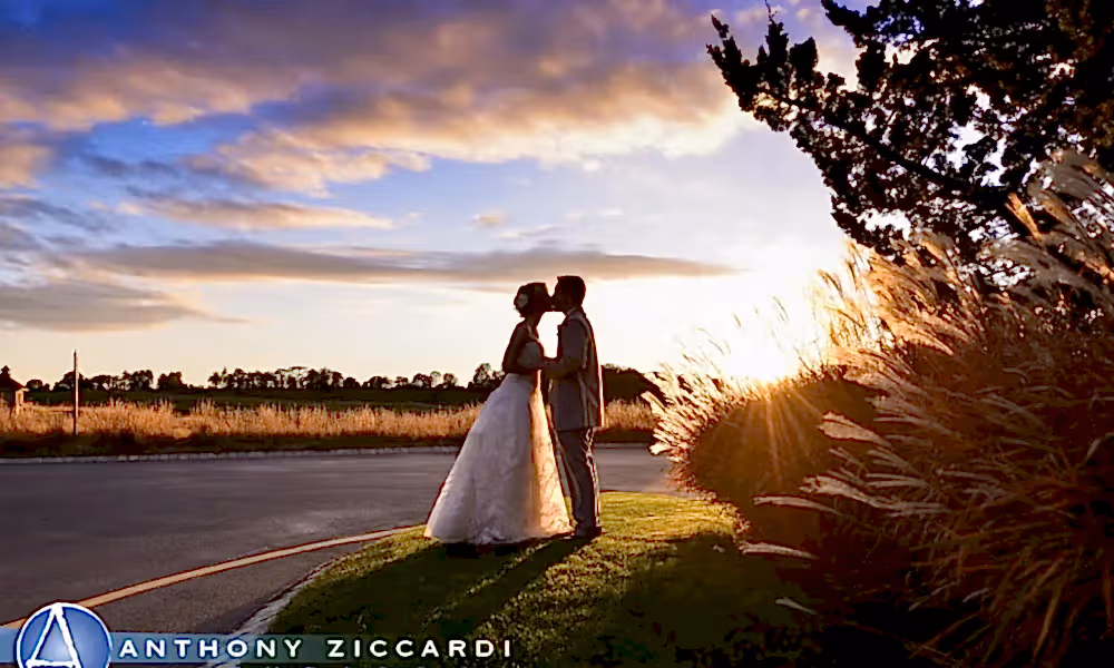 Beautiful wedding couple kissing at sunset