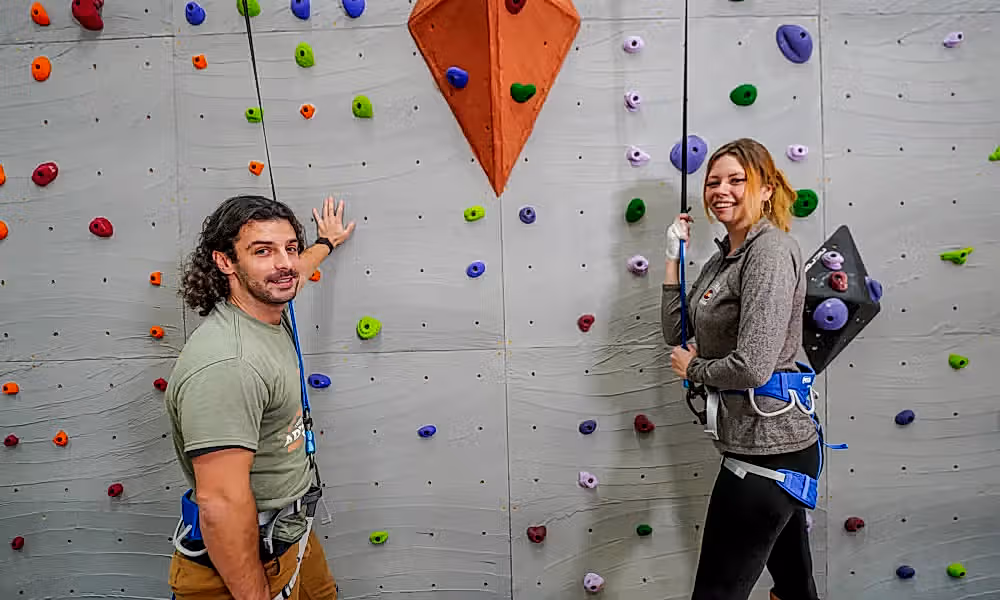 Two adults getting ready to rock climb.