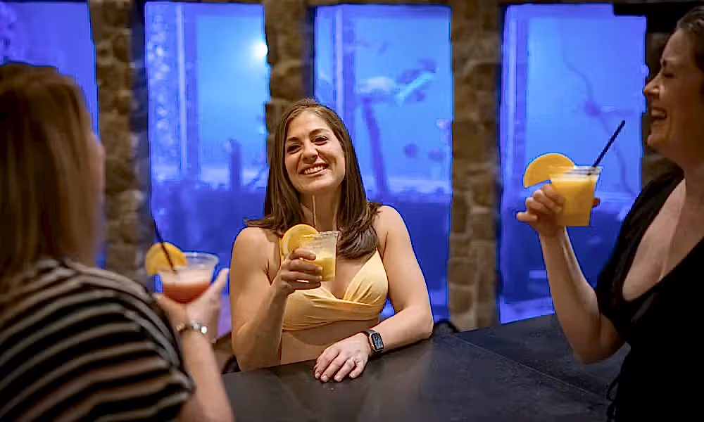 Three women enjoying drinks at The Pool Bar
