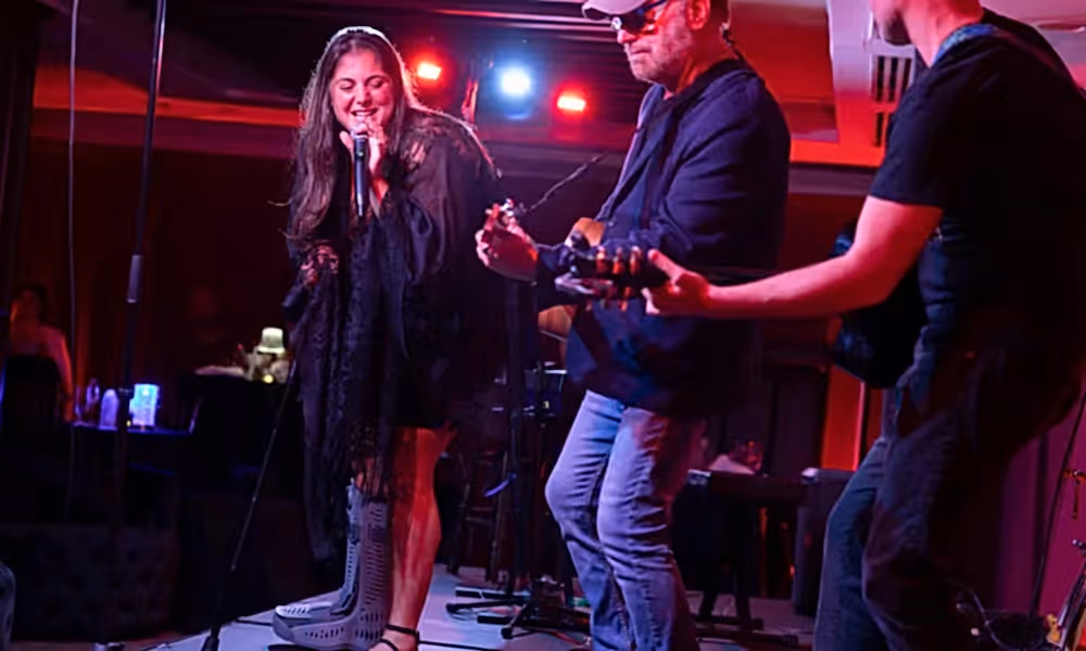 Singer and two guitar players on stage at Crystal Cabaret.
