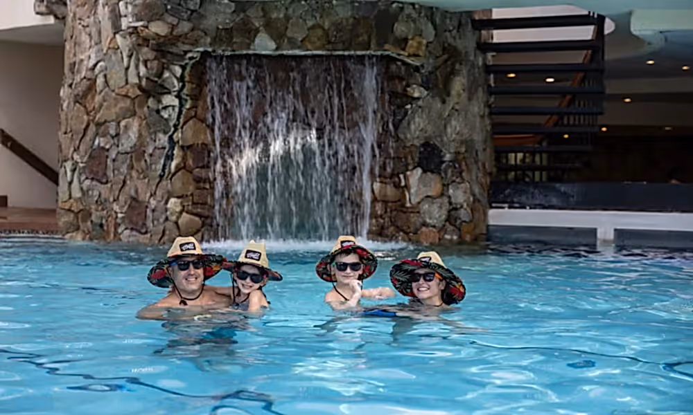 Family of four wearing matching lifeguard hats in Minerals Pool.