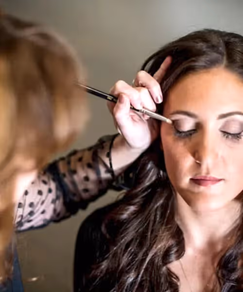Woman getting her eye makeup done.