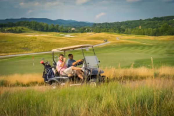 Guys riding on a golf cart at Ballyowen
