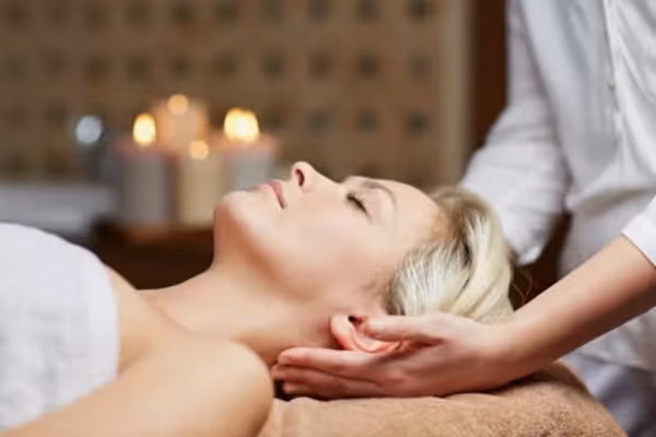 Blonde haired woman laying on spa table.