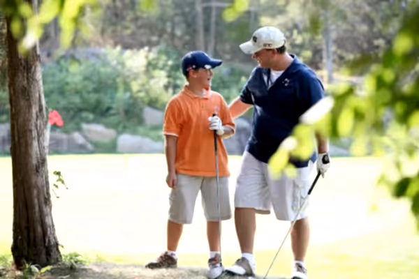 Father and son on a golf course at Crystal Springs Resort