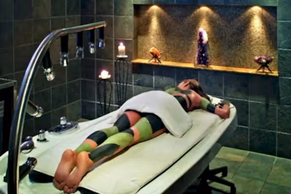 Woman receiving mud body treatment at Elements Spa.