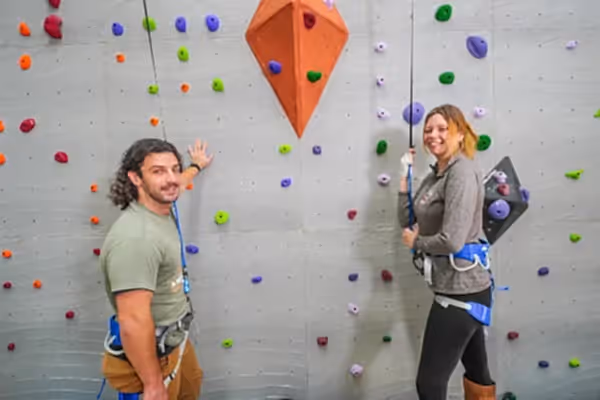 Two adults getting ready to rock climb.