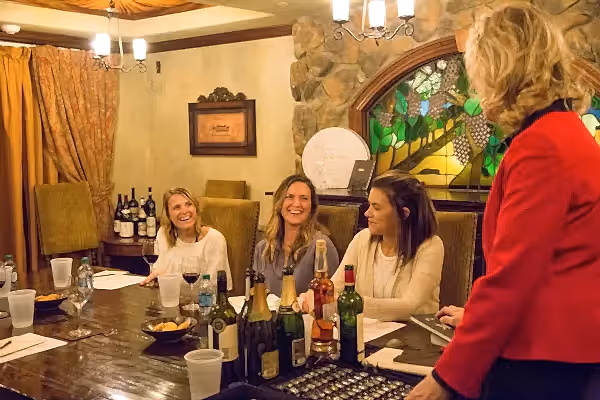 Group of three women do a wine tasting with wine sommelier, Susanne Wagner.
