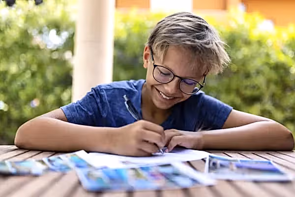 Child writing postcards
