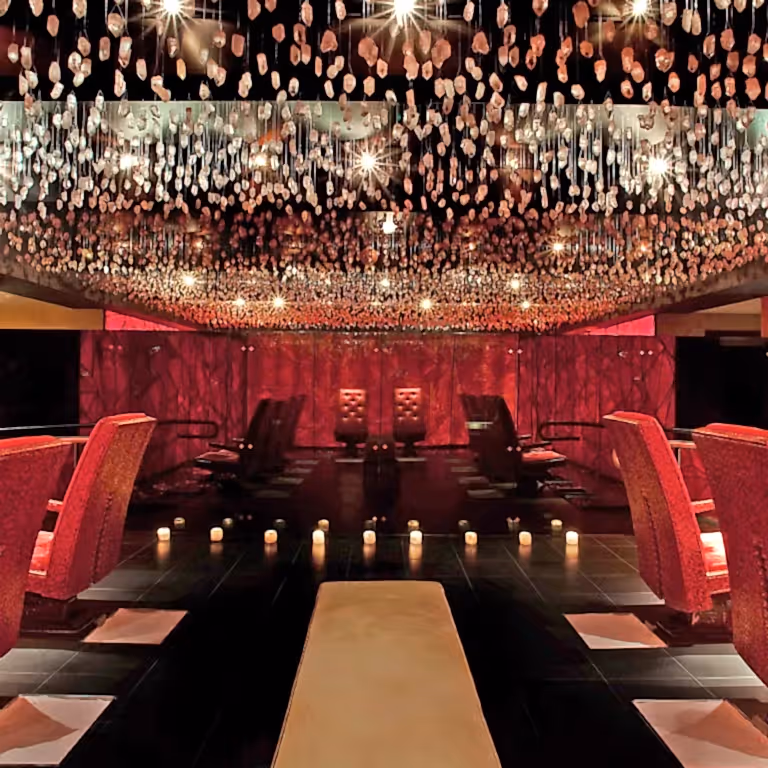 Crystal room at Reflections Spa featuring red chairs.