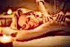 Woman laying on table receiving a back massage.